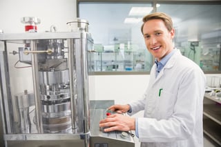 Tech working on a machine in a medical facility.